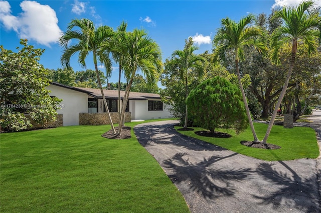 15201 SW 87th Ct, Palmetto Bay, FL 33157 - view of front facade featuring a front yard, driveway, and stucco siding
