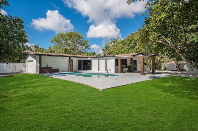 15201 SW 87th Ct, Palmetto Bay, FL 33157 - back of house with a patio area, a lawn, a fenced backyard, stucco siding, and a fenced in pool