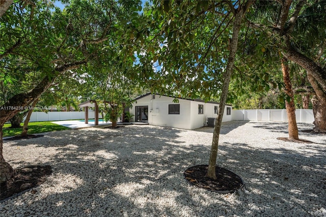 15201 SW 87th Ct, Palmetto Bay, FL 33157 - exterior space featuring a patio, a fenced backyard, central AC, and stucco siding