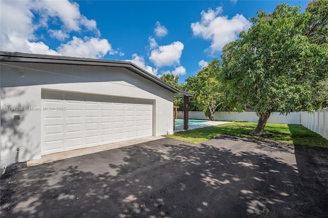 15201 SW 87th Ct, Palmetto Bay, FL 33157 - garage with aphalt driveway and fence