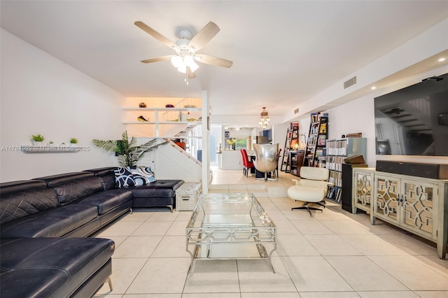tiled living room featuring visible vents and a ceiling fan