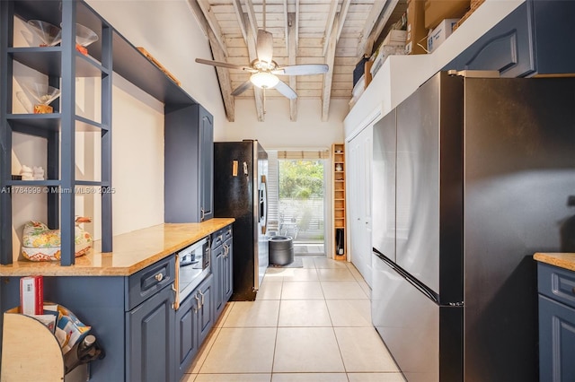 kitchen with freestanding refrigerator, a ceiling fan, stainless steel refrigerator with ice dispenser, beamed ceiling, and blue cabinets