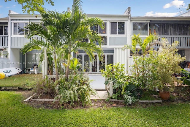 exterior space with a yard and a sunroom