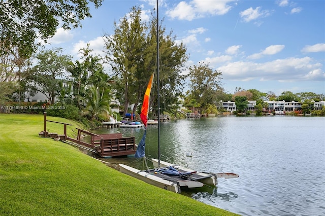 view of dock featuring a water view and a lawn