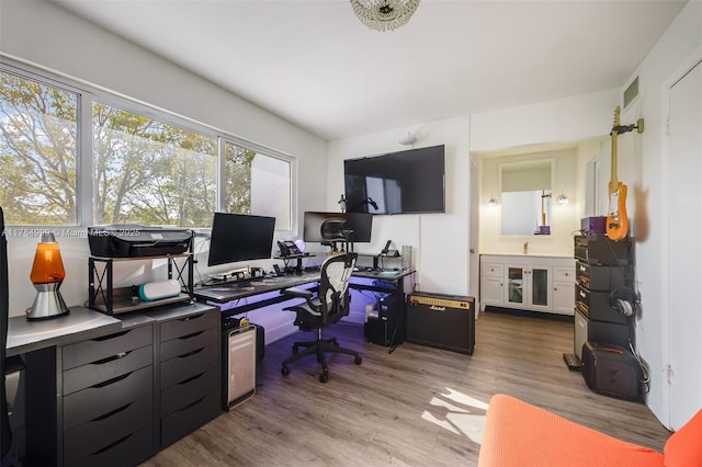 home office with visible vents and wood finished floors