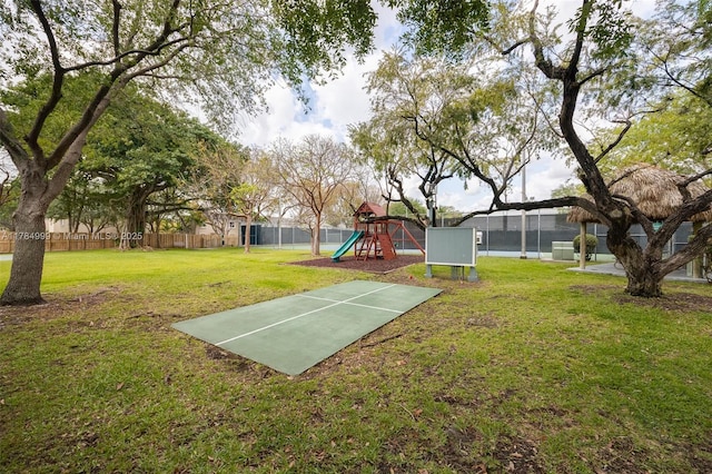 view of yard with fence and a playground