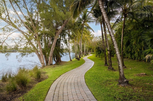 view of home's community featuring a water view and a lawn