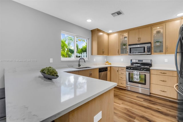 13473 NW 5th Ct, Plantation, FL 33325 - kitchen with visible vents, a sink, light countertops, appliances with stainless steel finishes, and light wood-style flooring