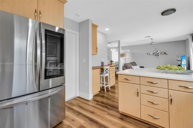 13473 NW 5th Ct, Plantation, FL 33325 - kitchen featuring light wood-style flooring, light brown cabinetry, light countertops, refrigerator with glass door, and open floor plan