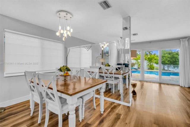 13473 NW 5th Ct, Plantation, FL 33325 - dining area featuring visible vents, baseboards, a notable chandelier, and wood finished floors