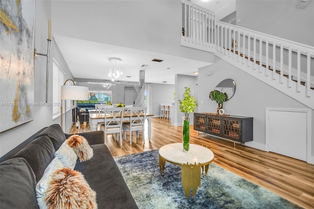 13473 NW 5th Ct, Plantation, FL 33325 - living room with wood finished floors, a notable chandelier, baseboards, and stairs