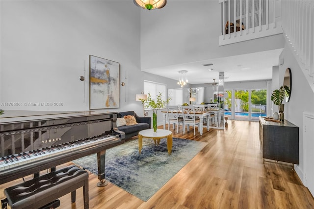 13473 NW 5th Ct, Plantation, FL 33325 - living area with wood finished floors, an inviting chandelier, and a towering ceiling