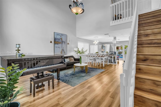 13473 NW 5th Ct, Plantation, FL 33325 - living area featuring a towering ceiling, a notable chandelier, wood finished floors, and stairs
