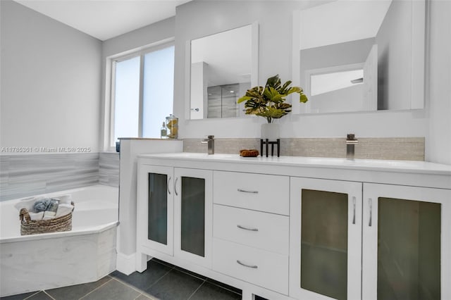 13473 NW 5th Ct, Plantation, FL 33325 - full bathroom featuring tile patterned floors, double vanity, a garden tub, and a sink
