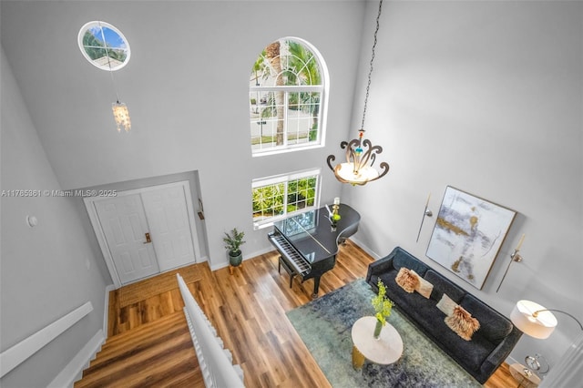 13473 NW 5th Ct, Plantation, FL 33325 - entryway with a chandelier, a high ceiling, baseboards, and wood finished floors