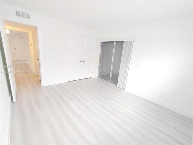 60 Burgundy B 60, Delray Beach, FL 33484 - unfurnished bedroom with visible vents, baseboards, and light wood-type flooring