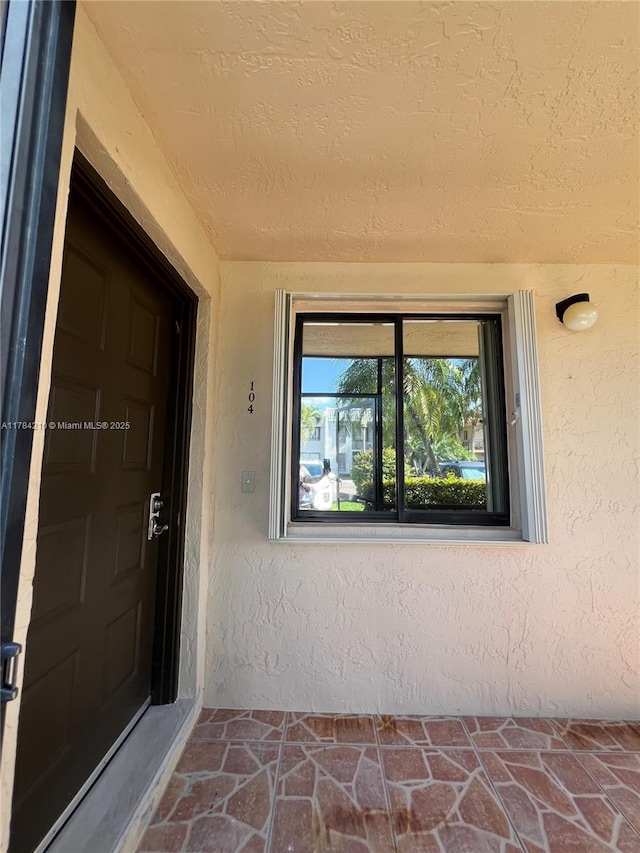 view of exterior entry with stucco siding