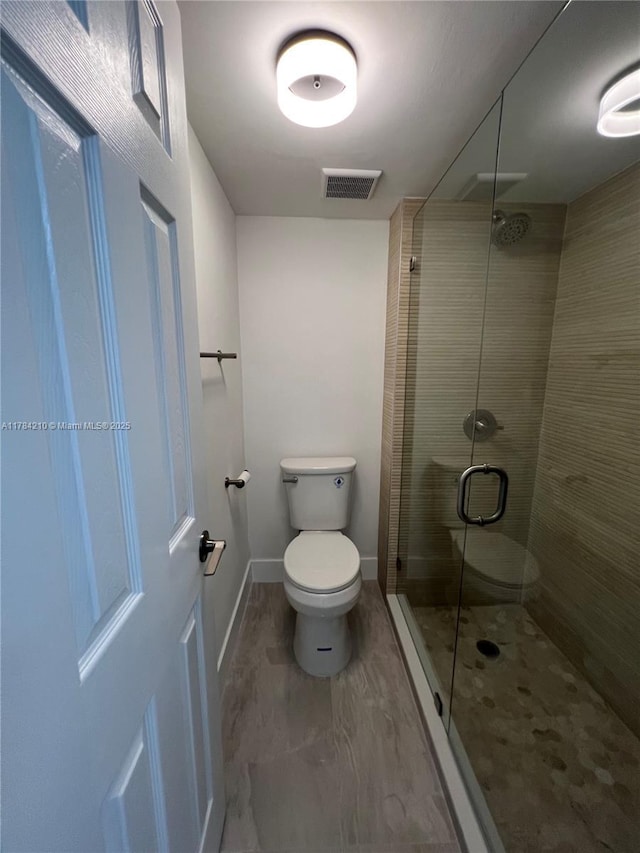 full bath featuring baseboards, toilet, a shower stall, visible vents, and marble finish floor