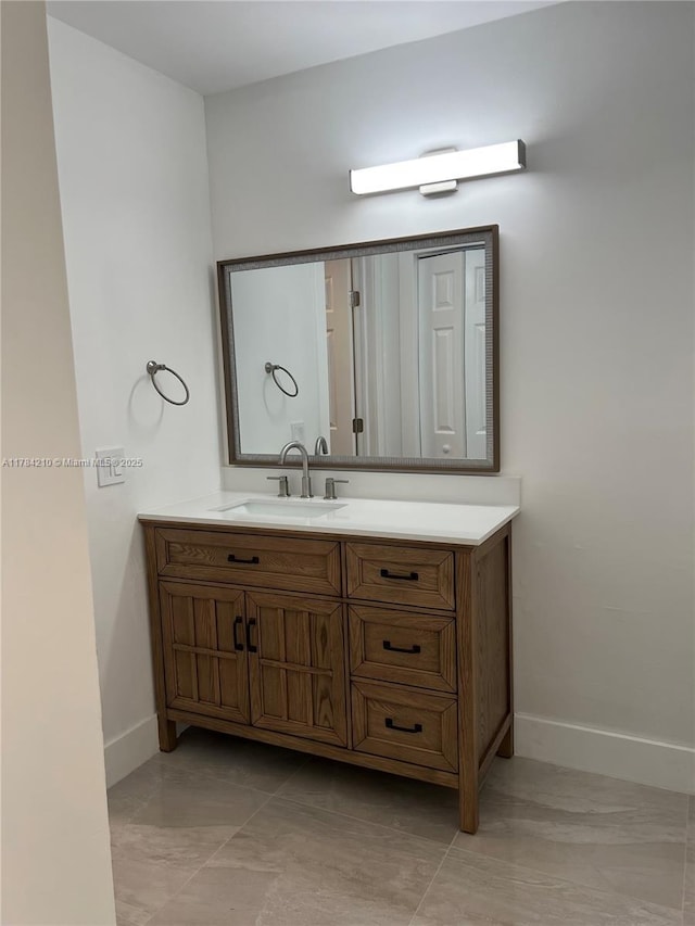 bathroom featuring vanity and baseboards