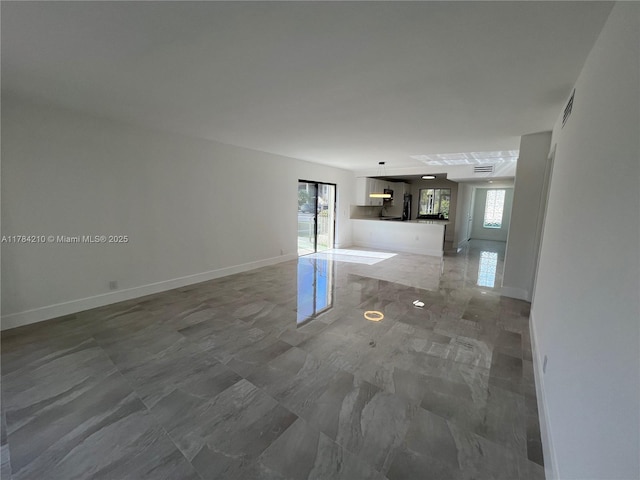 interior space with baseboards and visible vents