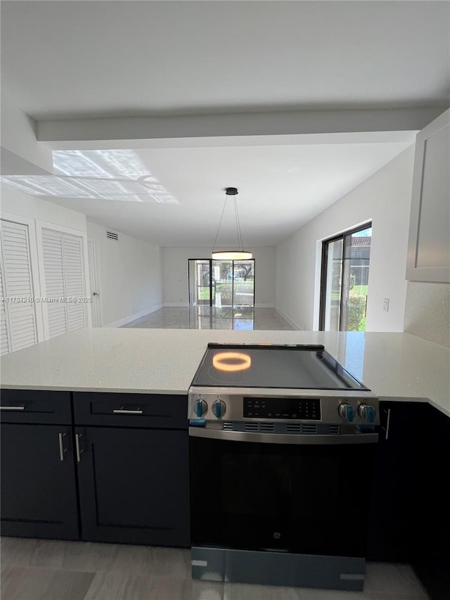 kitchen with dark cabinets, visible vents, pendant lighting, and stainless steel range with electric stovetop