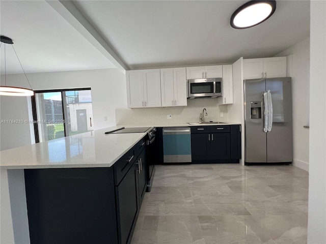 kitchen with white cabinets, marble finish floor, a sink, and appliances with stainless steel finishes