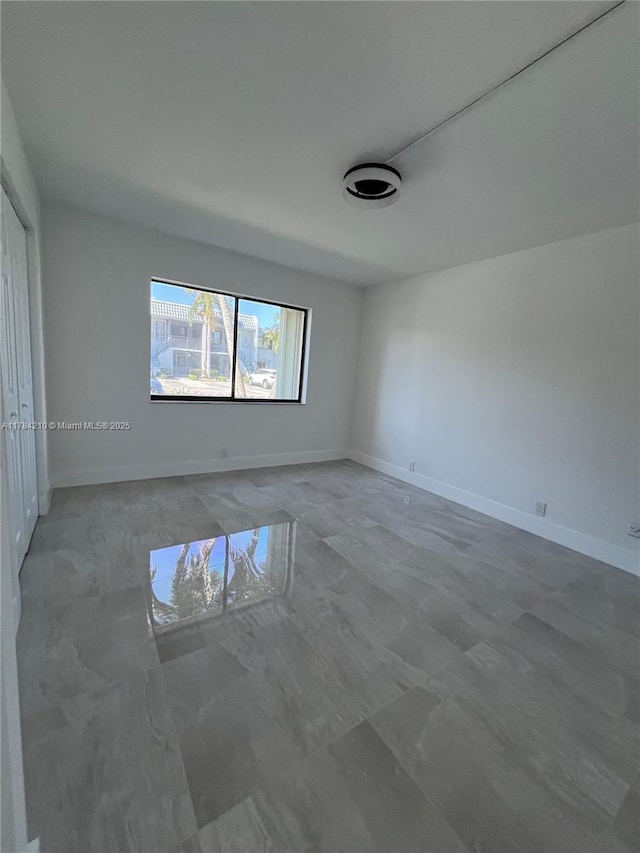 empty room featuring baseboards
