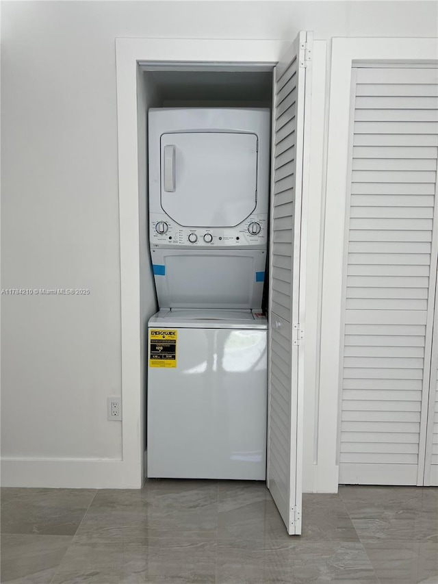 laundry area with stacked washer and clothes dryer and laundry area