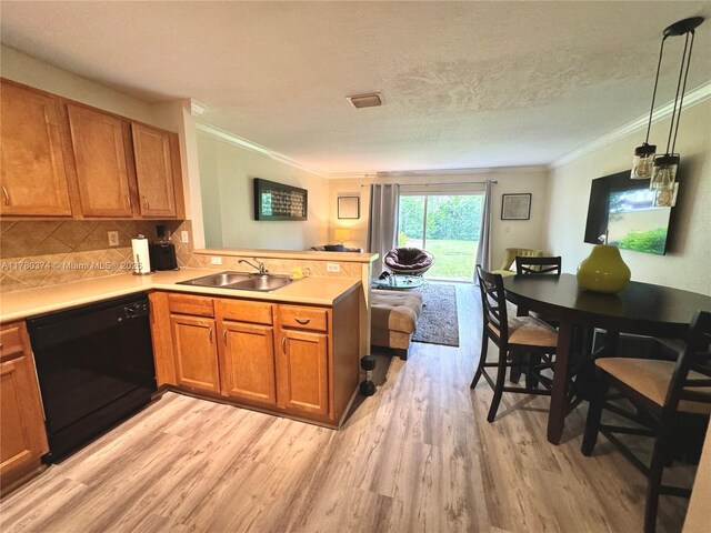kitchen featuring crown molding, dishwasher, a sink, and a peninsula