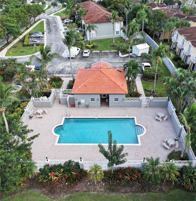 community pool featuring a patio and a fenced backyard