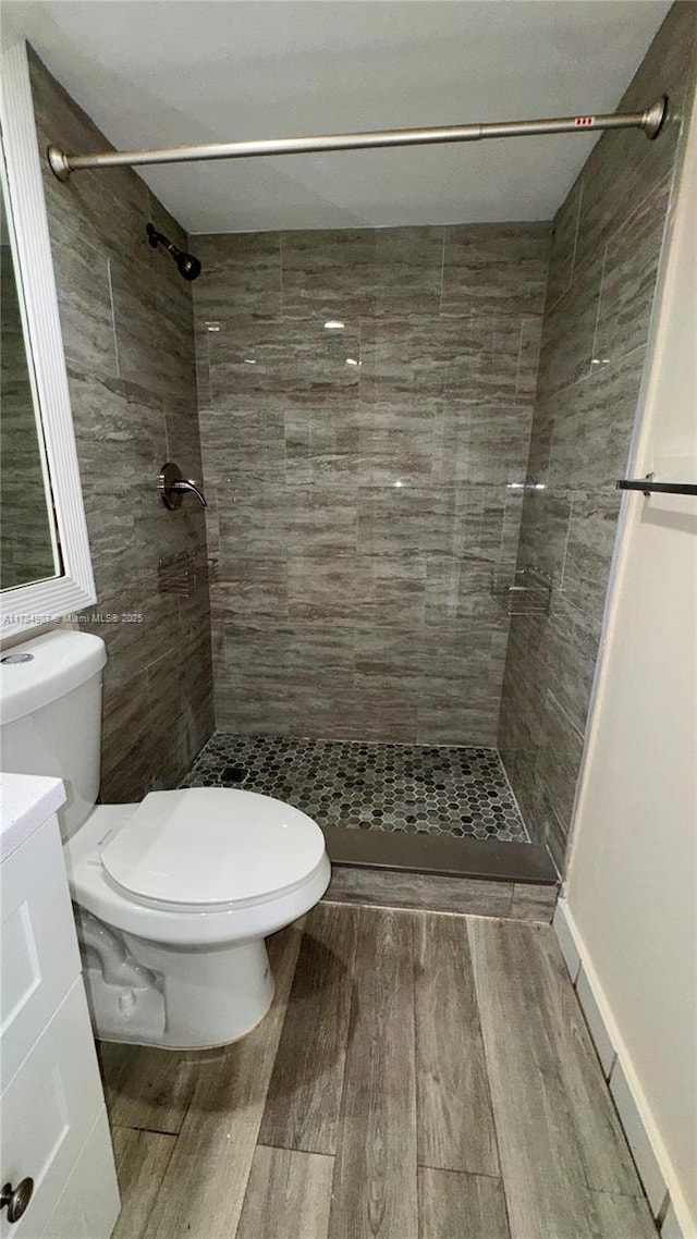 10795 SW 108th Ave Unit 103, Miami, FL 33176 - full bathroom featuring toilet, a stall shower, wood finished floors, and vanity