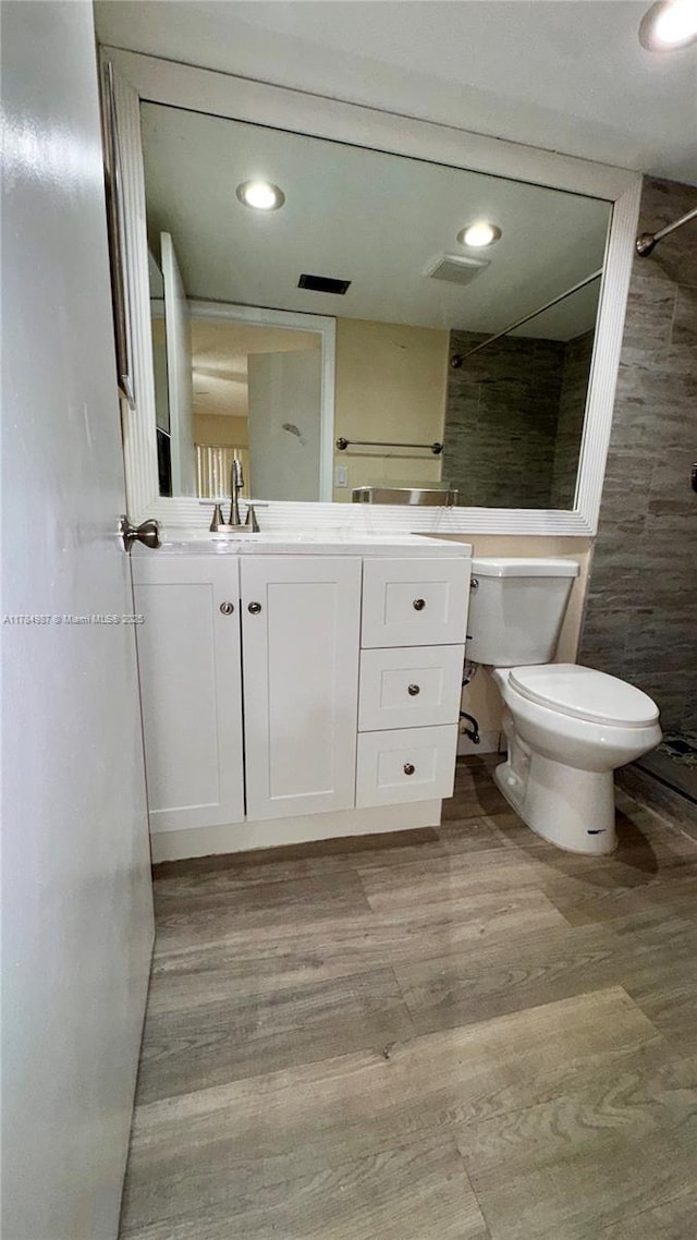 10795 SW 108th Ave Unit 103, Miami, FL 33176 - bathroom featuring toilet, wood finished floors, vanity, and visible vents