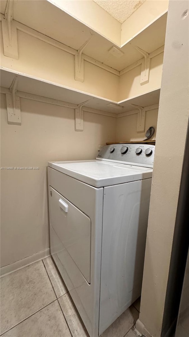 10795 SW 108th Ave Unit 103, Miami, FL 33176 - clothes washing area featuring washer / clothes dryer, baseboards, light tile patterned flooring, and laundry area