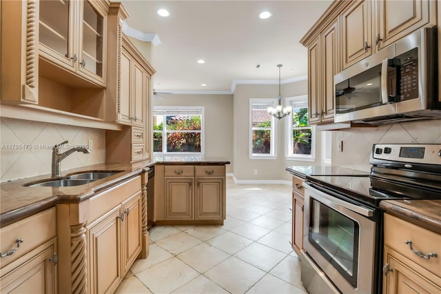 kitchen featuring stainless steel appliances, a sink, a ceiling fan, crown molding, and backsplash