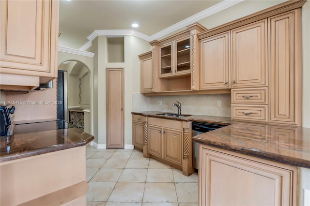 kitchen featuring a sink, stainless steel dishwasher, arched walkways, crown molding, and stove