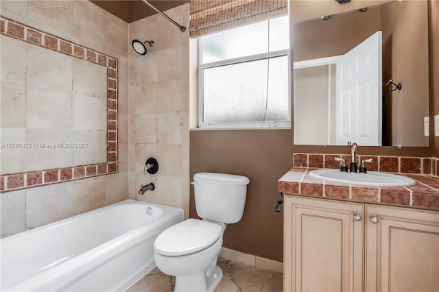 bathroom with toilet, shower / tub combination, vanity, and baseboards