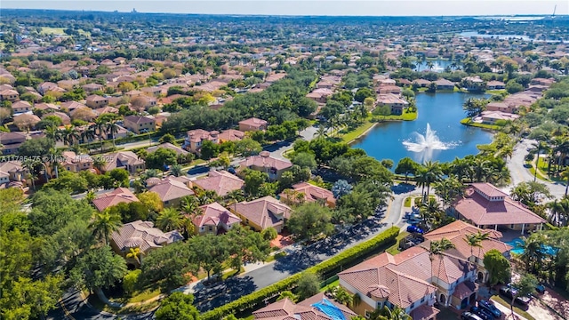 aerial view of property's location with a nearby body of water and nearby suburban area