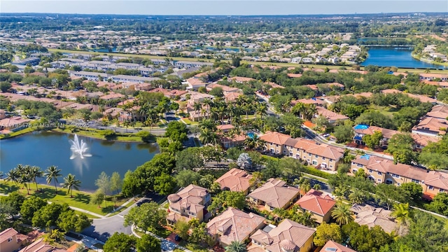 aerial view of residential area featuring a large body of water