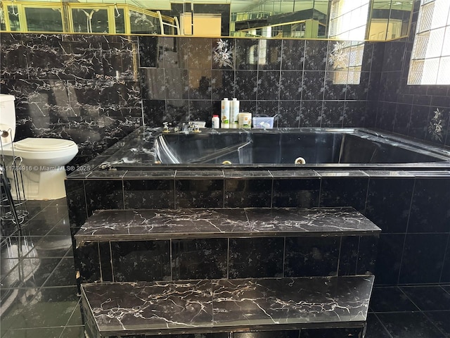 full bath featuring toilet and a tub with jets