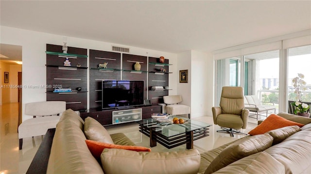 living room featuring visible vents and floor to ceiling windows