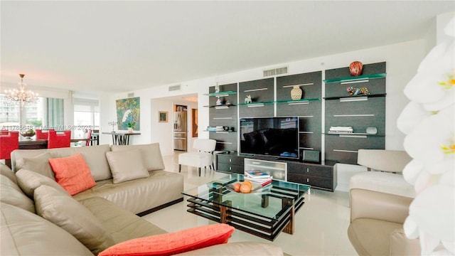 living area featuring a notable chandelier and visible vents