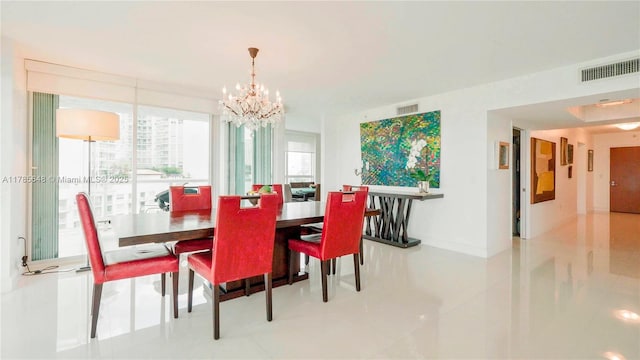 dining room with tile patterned floors, baseboards, visible vents, and a notable chandelier
