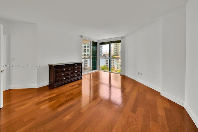 16500 Collins Ave Unit 656, Sunny Isles Beach, FL 33160 - unfurnished room featuring wood finished floors, baseboards, and expansive windows