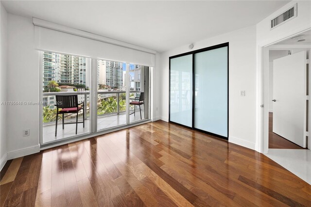 16500 Collins Ave Unit 656, Sunny Isles Beach, FL 33160 - spare room featuring wood finished floors, floor to ceiling windows, and baseboards