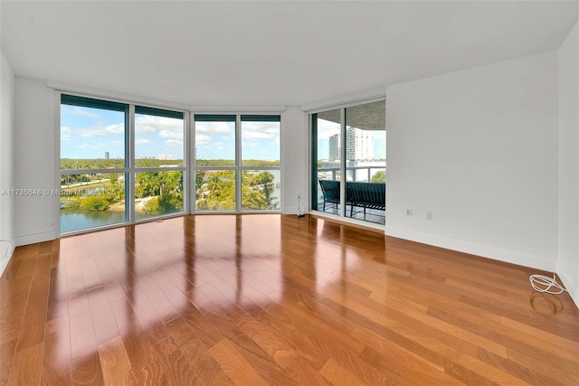 16500 Collins Ave Unit 656, Sunny Isles Beach, FL 33160 - spare room featuring a wall of windows, wood finished floors, and baseboards