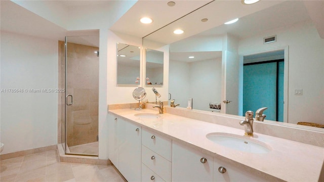 bathroom featuring recessed lighting, visible vents, a sink, and a shower stall