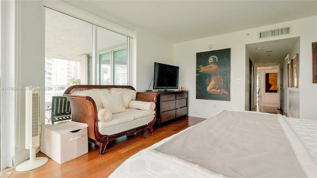 bedroom with wood finished floors and visible vents