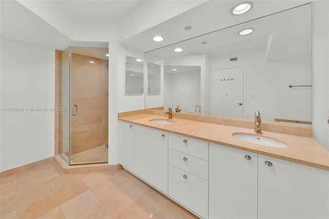 16500 Collins Ave Unit 656, Sunny Isles Beach, FL 33160 - full bathroom featuring double vanity, a shower stall, recessed lighting, tile patterned flooring, and baseboards