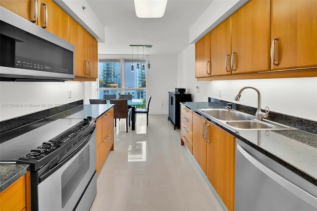 16500 Collins Ave Unit 656, Sunny Isles Beach, FL 33160 - kitchen with appliances with stainless steel finishes, a sink, and brown cabinetry