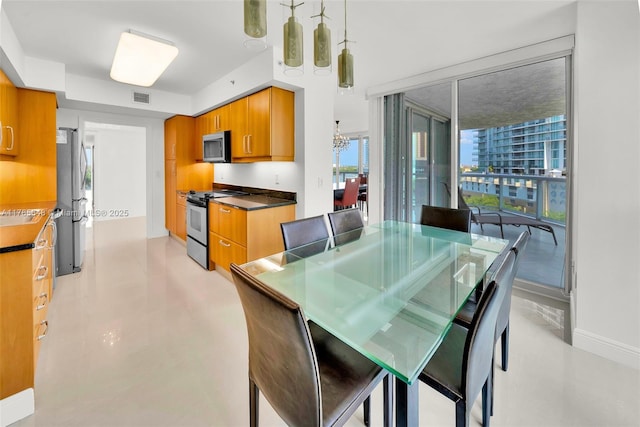 16500 Collins Ave Unit 656, Sunny Isles Beach, FL 33160 - dining space featuring a chandelier and baseboards